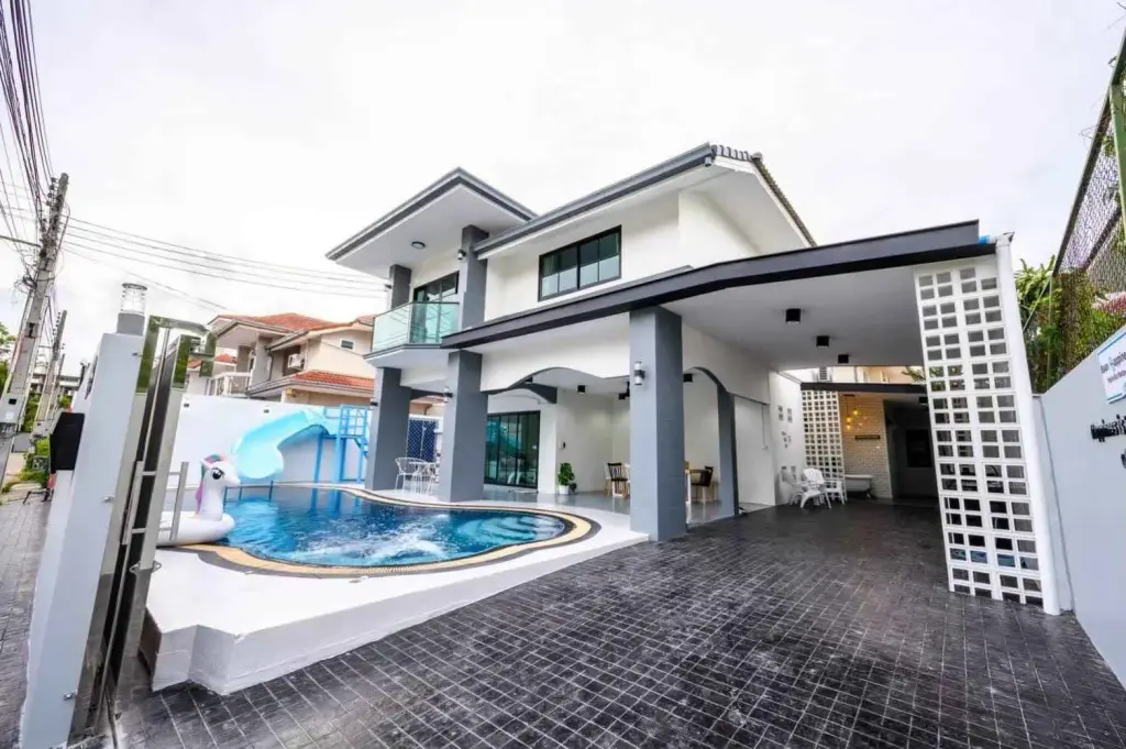6 Bedroom House for Sale & Rent in Jomtien exterior view with pool, water slide, and covered carport
