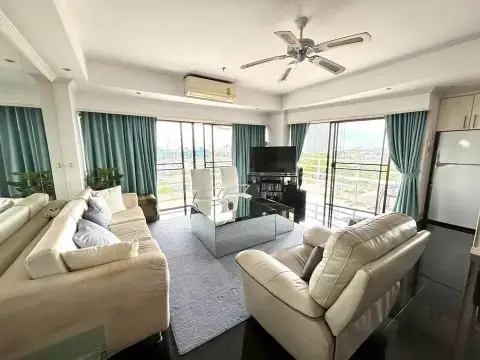 2 Bedroom Condo for Sale at Jomtien Beach Condominium lounge area with cream sofas and city view windows