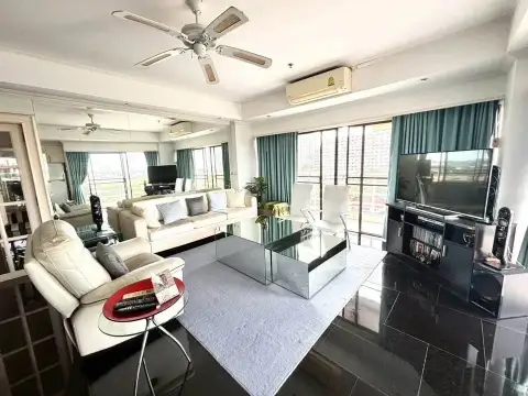 2 Bedroom Condo for Sale at Jomtien Beach Condominium open living space with TV unit and glass tables