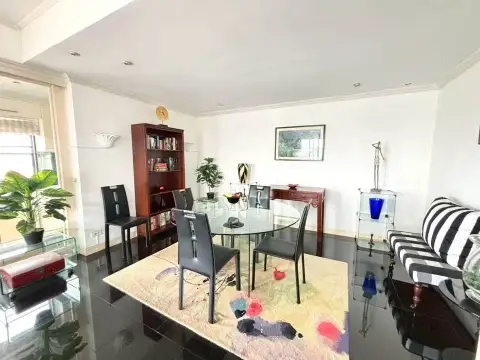 2 Bedroom Condo for Sale at Jomtien Beach Condominium dining area with glass table and bookshelf