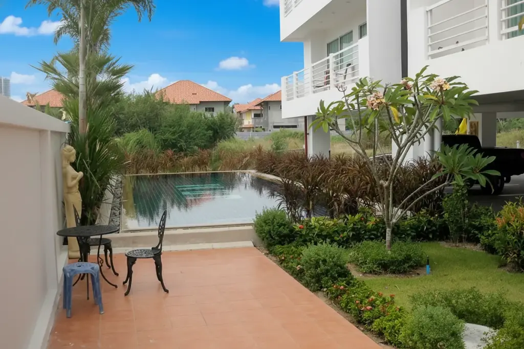 Jomtien Beach Mountain 2 private patio with terracotta tiles, outdoor seating, small pool, and lush garden.