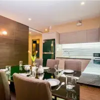 3 Bedroom House for Sale in Jomtien dining area with glass table set for meals next to open kitchen