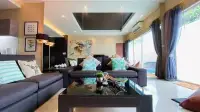 3 Bedroom House for Sale in Jomtien open-plan lounge with mirrored ceiling accent and tropical cushions