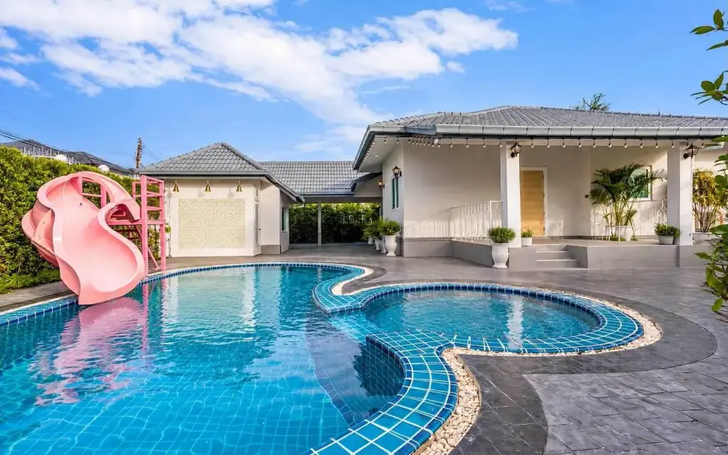 3 Bedroom House for Rent in Jomtien with curved swimming pool, pink water slide and poolside terrace