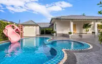 3 Bedroom House for Rent in Jomtien with curved swimming pool, pink water slide and poolside terrace