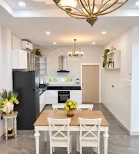 3 Bedroom House for Rent in Jomtien dining area with white chairs beside modern fitted kitchen