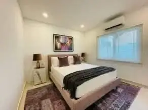 4 Bedroom House for Rent at Casa Jomtien bedroom with pink upholstered bed and wall art