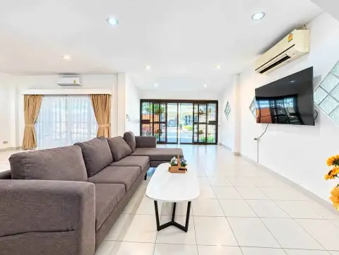 4 Bedroom House for Rent in Jomtien bright living room with sectional sofa and sliding glass doors