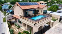 5 Bedroom House for Sale in Jomtien drone view of villa exterior with rooftop swimming pool and terrace