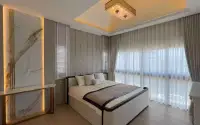 5 Bedroom House for Sale in Jomtien bedroom with upholstered bed and marble accent wall