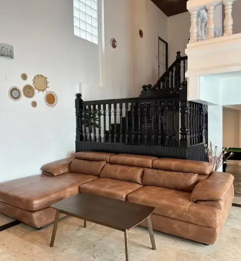 6 Bedroom House for Rent in Jomtien leather sectional sofa below black staircase railing