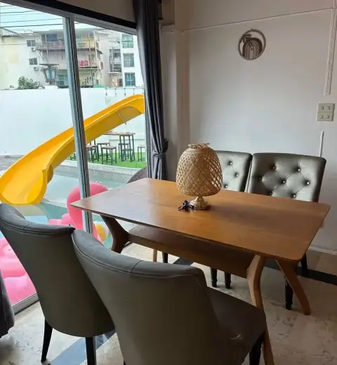 6 Bedroom House for Rent in Jomtien wooden dining table overlooking pool and slide