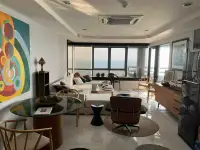 1 Bedroom Condo for Sale at Jomtien Plaza Condotel open-plan living room with sea view and modern decor