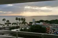 2 Bedroom Condo for Sale at Jomtien Plaza Condotel balcony view of sunset over Jomtien beach and palm trees