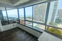 2 Bedroom Condo for Sale at Jomtien Plaza Condotel floor-to-ceiling windows overlooking high-rise buildings and sea