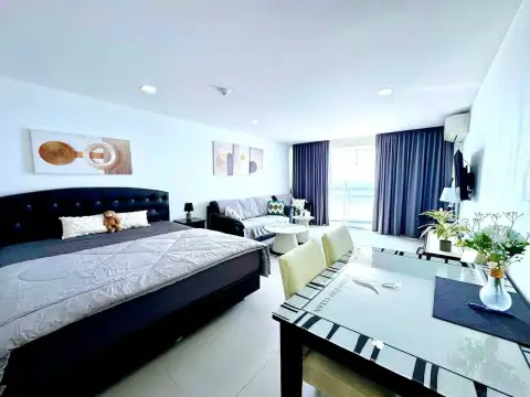 Studio Condo for Rent at Jomtien Plaza Condotel bedroom and lounge area with dining table and balcony access