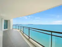 3 Bedroom Condo for Sale at Reflection Jomtien Beach curved private balcony overlooking turquoise sea