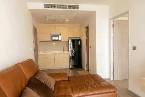 1 Bedroom Condo for Sale at Aeras open-plan kitchen with wooden cabinets and living area