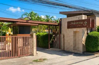 Baan Piam Mongkhon 3 entrance gate with stone wall and property name sign in Thai and English.