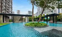 2 Bedroom Condo for Sale at Baan Plai Haad garden pool area with lounge pavilions and city backdrop