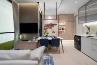 1 Bedroom Condo for Sale at Once Wong Amat: Open-plan living, dining, and kitchen area with modern furnishings and a washing machine.