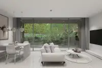 2 Bedroom Condo for Sale at Celine Wongamat open-plan living and dining area with floor-to-ceiling windows overlooking lush garden