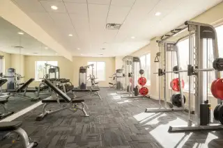 Northshore Pattaya recreation room with a green billiards table and exercise equipment visible through large windows.