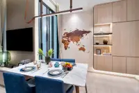 1 Bedroom Condo for Sale at Once Wong Amat: Dining area with a marble table, blue chairs, wooden wall map, and built-in shelving.