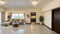 3 Bedroom Condo for Sale at Keha Thepprasit open-plan living area with chandelier lighting and view into kitchen