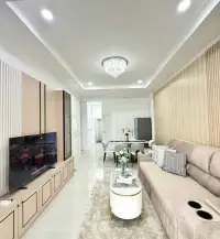 3 Bedroom House for Sale in East Pattaya long living room view with TV unit, sofa and dining area