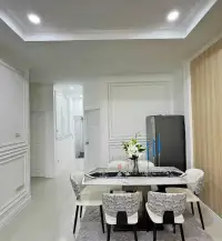 3 Bedroom House for Sale in East Pattaya dining area with marble table, patterned chairs and floral centerpiece