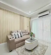 3 Bedroom House for Sale in East Pattaya living room with beige sofa, coffee table and curtained balcony door