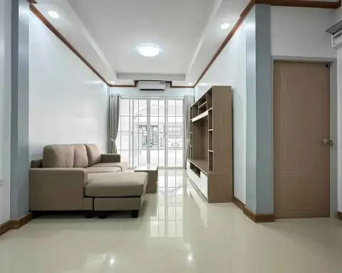 2 Bedroom Townhouse for Sale in East Pattaya bright living room with sofa, wall unit, and garden view window