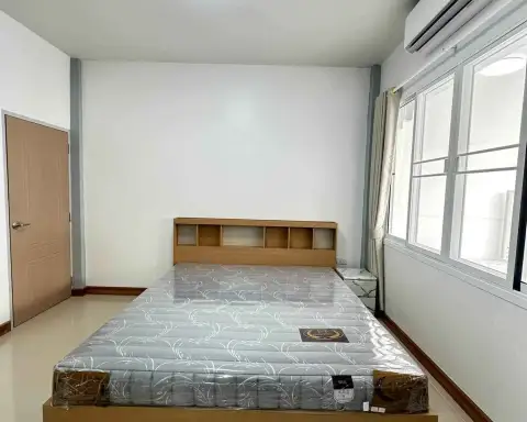 2 Bedroom Townhouse for Sale in East Pattaya bedroom with wrapped mattress bed and wall-mounted air conditioner