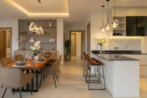 4 Bedroom House for Sale at Zensiri Lakeside Pool Villas dining area with wooden live-edge table and kitchen island with dark marble countertop