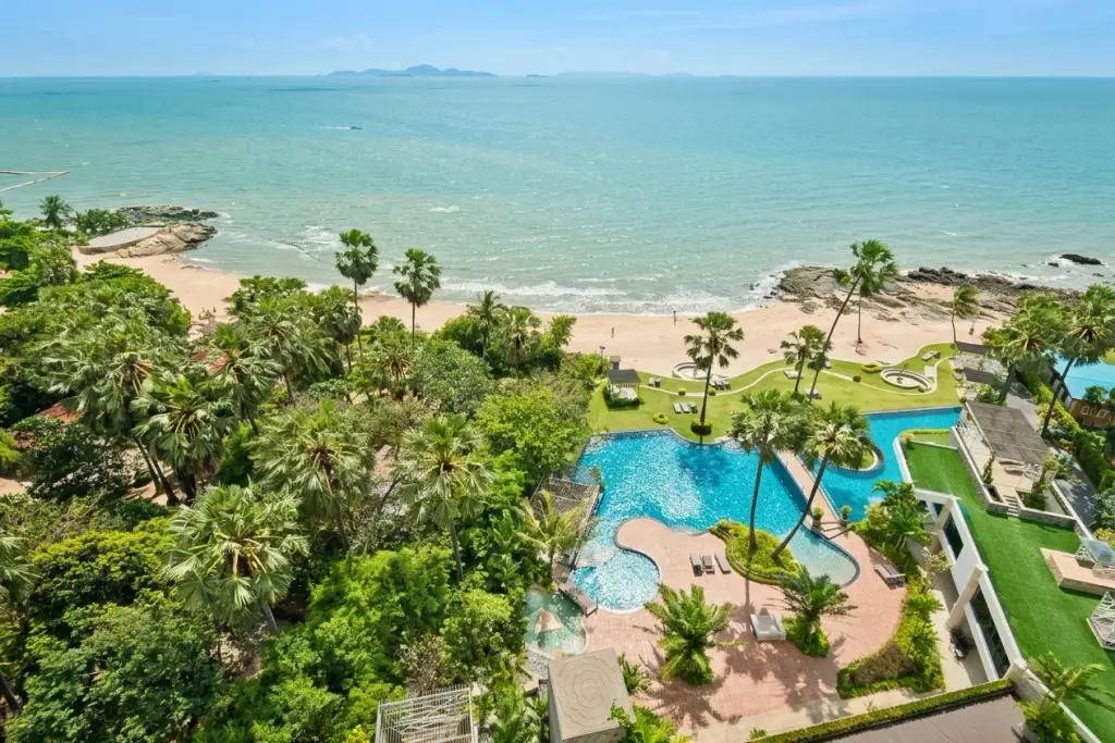 1 Bedroom Condo for Sale & Rent at Palm Wongamat aerial view of beachfront pool, tropical gardens and sea