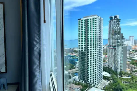 1 Bedroom Condo for Sale at The Twin Tower Jomtien Beach Pattaya high-floor window view of twin towers and Pattaya Bay coastline