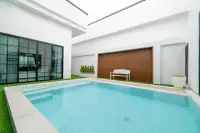 3 Bedroom House for Sale & Rent at PCK Villa courtyard swimming pool with entry steps, artificial grass, white bench and wood accent wall