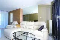 3 Bedroom Condo for Sale at Apus bright living room with white L-shaped leather sofa and mirror accent wall