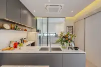 4 Bedroom House for Sale at Cascade kitchen island with marble countertop, steel sink and grey cabinetry