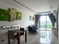 1 Bedroom Condo for Sale at Laguna Beach Resort 1 living room with balcony access, city view, and floral wall art