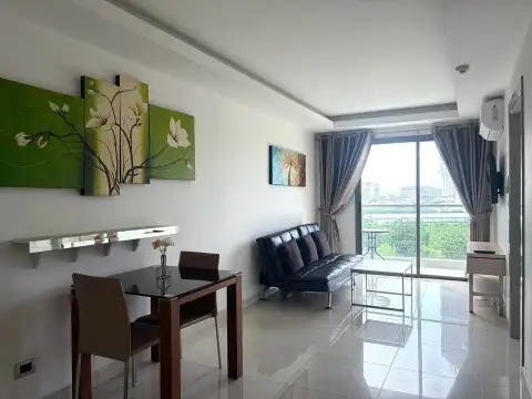 1 Bedroom Condo for Sale at Laguna Beach Resort 1 living room with balcony access, city view, and floral wall art