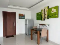 1 Bedroom Condo for Sale at Laguna Beach Resort 1 dining nook with wooden table, refrigerator, and entrance door