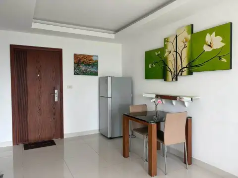 1 Bedroom Condo for Sale at Laguna Beach Resort 1 dining nook with wooden table, refrigerator, and entrance door