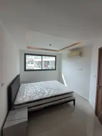 1 Bedroom Condo for Sale at Laguna Beach Resort 3 (The Maldives) bedroom with bed, wall-mounted AC unit, and large window