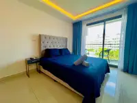 1 Bedroom Condo for Sale at Laguna Beach Resort 3 (The Maldives) bedroom with navy bedding and balcony view