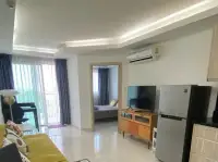 1 Bedroom Condo for Sale at Laguna Beach Resort 1 living room with TV, fridge, and bedroom entrance