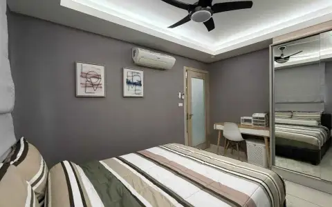 2 Bedroom Condo for Rent at Laguna Beach Resort 1 second bedroom with striped bedding, desk and mirrored closet