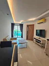 1 Bedroom Condo for Rent at Laguna Beach Resort 2 living room with leather sofa, TV unit, and balcony pool view