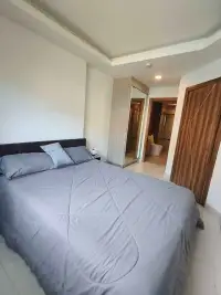 1 Bedroom Condo for Rent at Laguna Beach Resort 2 bedroom with gray bedding, mirrored wardrobe, and ensuite bathroom
